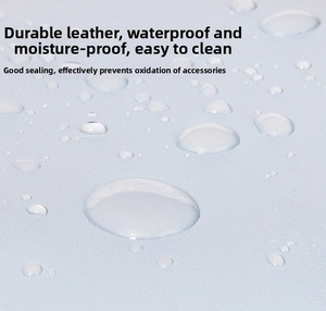Waterproof detail of light blue leather jewelry box with water drops on textured surface
