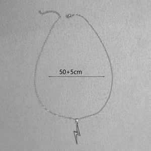Detail view of silver lightning bolt necklace with 50+5cm size indicator on grey background
