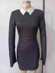 Detailed view of black sequined party dress with pearl embellished contrast collar