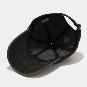 Detail of grey washed cotton baseball cap showing inner sweatband and metal buckle