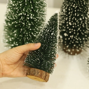 Miniature snow-flocked Christmas trees with natural wood base in three different sizes