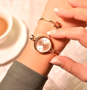 Elegant rose gold watch and star bracelet set shown on wrist for a minimalist style