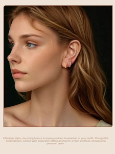 Close-up of elegant gold and silver hoop earrings with sparkling small diamonds on ears