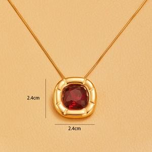Detailed view of 18K gold plated square flower pendant with red zircon and 2.4cm size scale