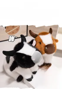 Close-up of fluffy black and brown plush cow dolls with detailed horns and soft texture