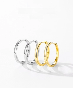 Detailed view of S925 sterling silver hoop earrings with polished gold and silver finishes