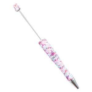 DIY plastic beaded pen featuring colorful floral and butterfly patterns on white barrel