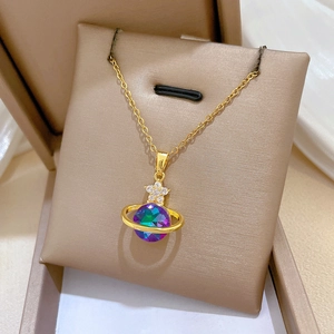 Macro view of gold Saturn pendant with colorful aurora crystal and sparkling diamond flower
