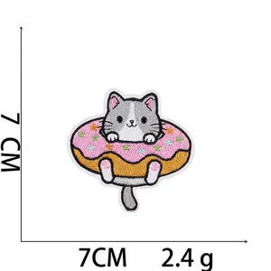 Detailed embroidery patch showing a cute cat in a pink donut with 7cm x 7cm dimensions