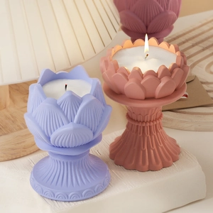 Detailed view of lit lotus-shaped candle holders in dusty pink and lavender silicone molds