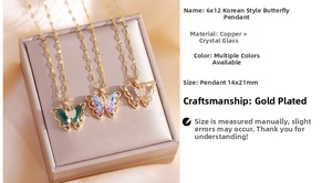 Detail of crystal butterfly pendant necklaces in gold plating with colorful micro-insets
