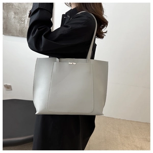 Gray large capacity PU leather tote bag shown on model for daily commuting style