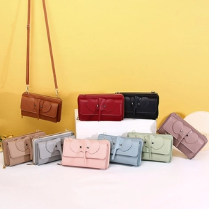 Detail of cute elephant crossbody phone bags in various colors with long straps