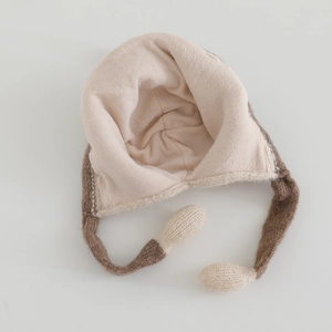 Detail of knitted winter hat showing the soft plush fleece lining and earflaps for warmth