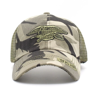 Detail of navy seal embroidery on camouflage mesh hat with breathable green net