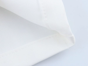 Detail shot of double-needle stitching and white cotton hem on commuter style set