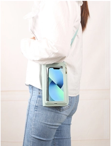 Detail of light blue crossbody phone bag with transparent screen for touch control