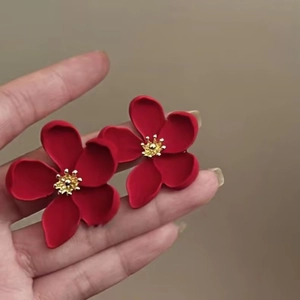 Three-dimensional matte red five-petal flower earrings with a golden metallic stamen center