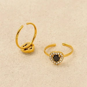 Close-up of gold-plated heart ring featuring black gemstone and white zircon accents
