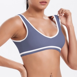 Close-up of gray-blue sports bra featuring white contrast piping and high-stretch fabric