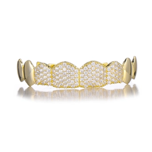 Macro shot of gold hip hop grillz featuring micro-paved white zircons and mirror reflection
