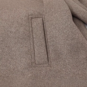 Fashionable brown wool blend short coat jacket featuring high-quality stitching and pocket details