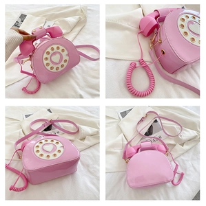 Detailed views of a pink vintage telephone crossbody bag with glossy patent leather finish
