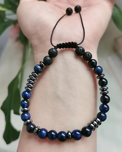 Close-up of You Are Loved Morse code bracelet with blue tiger eye and lava stones