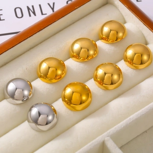 Polished half-round stud earrings in gold and silver finish on a white velvet display
