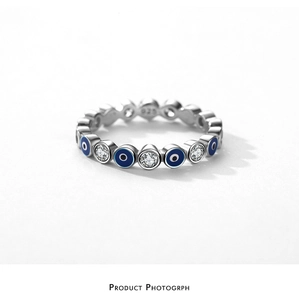 Macro shot of S925 silver evil eye ring with blue enamel and sparkling cubic zirconia