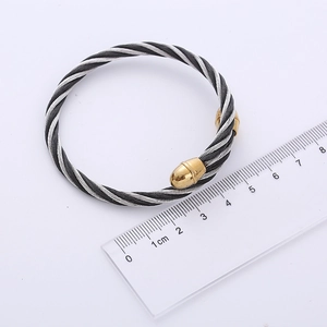 Braided steel wire open bracelet with silver cable texture and gold teardrop tips