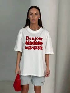 Detailed view of oversized white cotton t-shirt with red Bonjour Madame graphic print