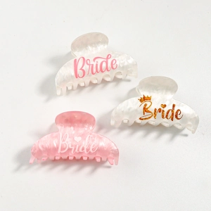 Three acetate bride hair claws in white and pink colors with heart and crown designs