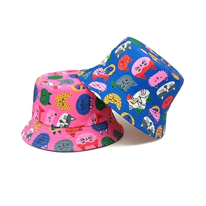 Reversible children's bucket hat with cute cartoon cat prints in pink and blue colors