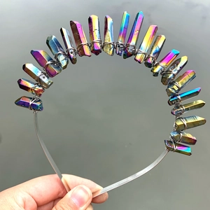 Detailed close-up of rainbow aura crystal raw stones hand-wrapped with metal wire on headband