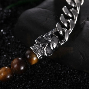 Detail of silver skull pendant with tiger eye beads and stainless steel cuban chain