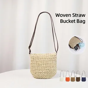 Handwoven straw bucket bag with leather strap for summer beach holidays in natural beige