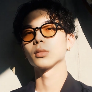 Retro small round sunglasses with black frames and orange lenses for a stylish vintage look