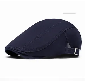 Detail of navy blue cotton flat cap featuring adjustable silver metal side buckle and stitching