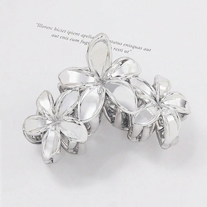 Metallic silver plumeria hair claw clip with three linked flower shapes for elegant styling
