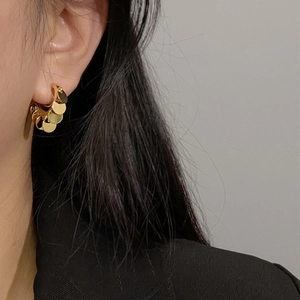 Elegant gold sequin hoop earrings for women featuring layered metallic discs on model