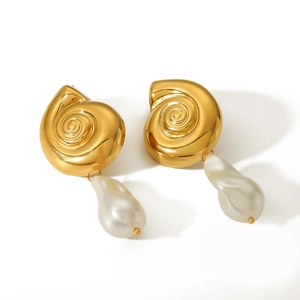 Detailed shot of gold conch shell stud earrings featuring irregular baroque pearl drops