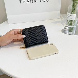 Close-up of black chevron quilted PU leather wallet showing gold zipper and mini size