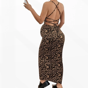 Detail of sexy leopard print maternity dress featuring a backless halter design with ties