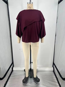 Detail of burgundy short sleeve top with asymmetrical layered ruffle design