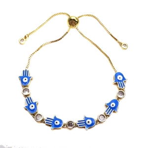 Adjustable golden Hamsa Hand bracelet with blue evil eye charms and crystal accents