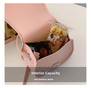 Detail view of the interior capacity of a pink mini crossbody bag for kids