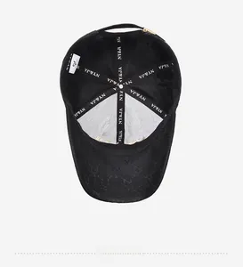Detail view of black baseball cap interior with branded stitching and gold metal buckle