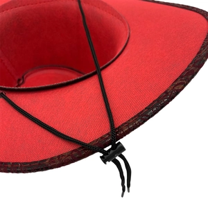 Detail view of red cowboy hat with black windproof chin strap and adjustable toggle