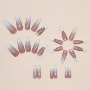 Long ballet press-on nails with white French tips, nude gradient, and rhinestone accents